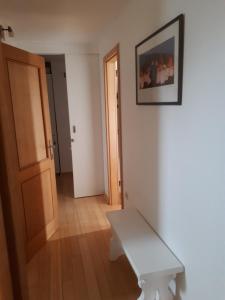 a white bench sitting in the corner of a room at Apartment Mamut in Premantura