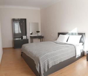 a bedroom with a large bed and a bathroom at Sunny Mountain House in Kazbegi