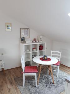 a dining room with a table and two chairs at Apartment Mamut in Premantura
