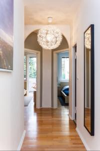 a hallway with a chandelier in a house at Cosy flat in trendy Sprengelkiez (legal) in Berlin