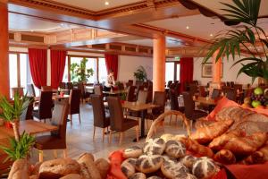 a room filled with tables and chairs with lots of bread at Hotel Belle Vue in Vianden