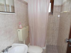 a bathroom with a toilet and a shower and a sink at Moradia Vale da Telha in Aljezur +23 photos