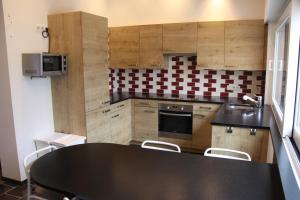 une cuisine avec une table noire et des chaises dans l'établissement Villa Zonneweelde, au Coq