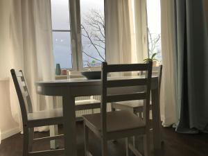 a table and chairs in front of a window at AquaGate Jurmala in Jūrmala
