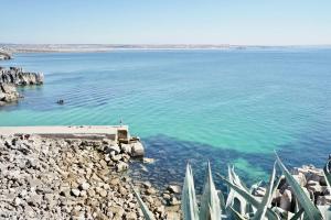 a view of a body of water with a pier at Deluxe Oceanfront - Vue Sur la Mer in Peniche