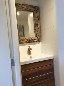 a bathroom with a sink and a mirror at Beach House Milou zandvoort Private Parking in Zandvoort
