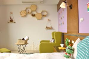 a childrens room with a bed and a chair at PHSEA INN in Magong