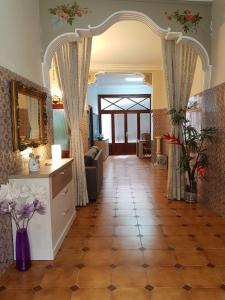 a living room with a tile floor and an archway at Casual House Valencia in Valencia