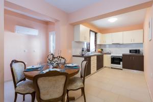 a kitchen with a table and chairs in a room at Eleni's cozy apartment in Tsilivi in Gaïtánion