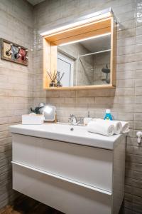 a bathroom with a white sink and a mirror at LOFT in Varna City