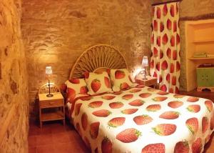 een slaapkamer met een bed met een ananas sprei bij Can Gasol Turisme Rural registre generalitat PT-00152 in Guialmons