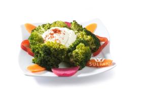 a plate of broccoli with ice cream and vegetables at Sultan Hotel in Sivas