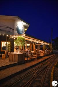 a train station with a table and chairs at night at Le Pavillon Bleu in Cap-Ferret