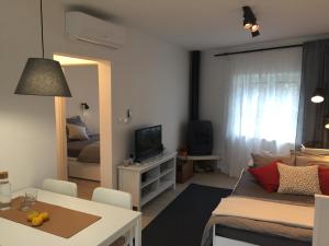 a small living room with a couch and a table at House Olivia in Pučišća