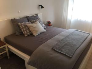 a bedroom with a large bed with pillows at House Olivia in Pučišća