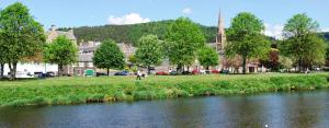a river in front of a town with a building at 6 Northgate Vennel, Peebles in Peebles