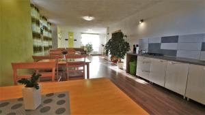 a kitchen and dining room with tables and chairs at Penzion Katka in Veľká Lomnica