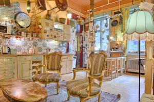 a kitchen with chairs and a table and a counter at Lavender Circus Hostel, Doubles & Ensuites in Budapest