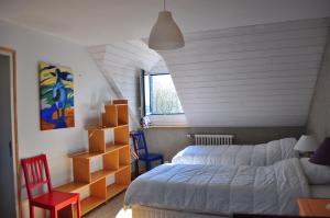 een slaapkamer met een bed, een bed en een stoel bij Domaine de Kernanou in Ploërmel