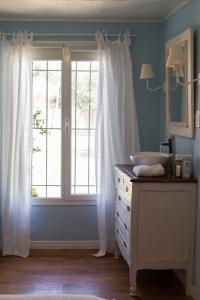 a bathroom with a sink and a window at Finca el Maitén Hotel Boutique in San Rafael