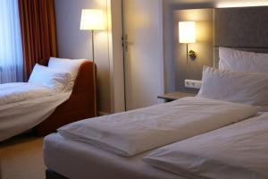 Säng eller sängar i ett rum på Land-gut-Hotel Allerhof