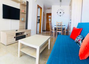 a living room with a couch and a table at Holiday Apartment 5 min to Levante beach in Benidorm