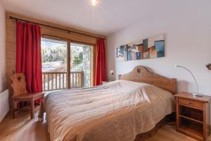 a bedroom with a large bed and a window at Arc 1800 Alpage du chantel Iseran SKI-in SKI-out in Arc 1800