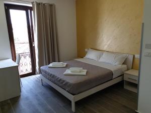 Giường trong phòng chung tại Giò Rooms