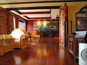 a living room with a large painting on the wall at Prince Edouard Apartments & Resort Patong Beach Phuket in Patong Beach
