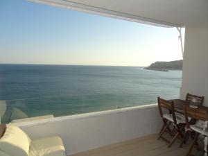 a room with a view of the ocean from a balcony at Akisol Sesimbra Beach III in Sesimbra