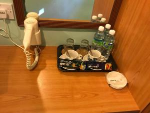 a tray of drinks and a phone on a door at Hotel Seri Kangsar KK Hotel in Kuala Kangsar