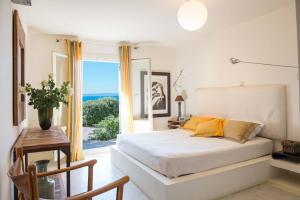 a bedroom with a bed with a view of the ocean at Villa Yalita in Melissaki
