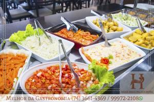 a buffet of different types of food on a table at Xique Xique Palace Hotel in Xique-Xique