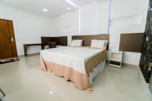 Säng eller sängar i ett rum på Xique Xique Palace Hotel