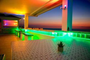 a swimming pool with green lights on a building at The Escape San Juan in San Juan