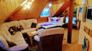 ein Wohnzimmer mit 2 Sofas und einem Tisch in einer Hütte in der Unterkunft Apartment U Malše 12 in Budweis