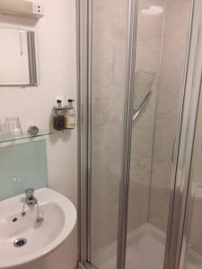 a bathroom with a shower and a sink at Carlton Hotel in Ilfracombe