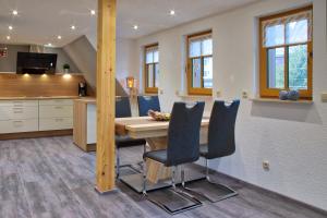 a kitchen and dining room with a table and chairs at Ferienhaus Fam. Herklotz in Seiffen