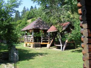 a gazebo with a playground in a park at Cabana Dochita in Ceahlău