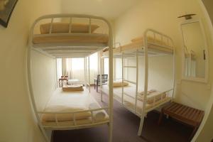two bunk beds in a room with a mirror at Railway Lodge Hostel in Hatton
