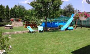 a yard with a playground with a slide at Papp Apartman Felsőörs in Felsőörs