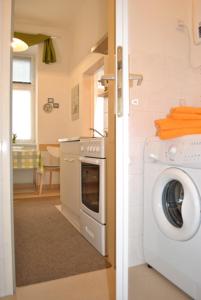 a kitchen with a washing machine and a washer at Apartment Haydnpark in Vienna
