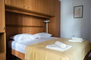 a bedroom with a bed with two towels on it at Apartmani Marko in Makarska