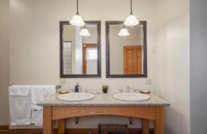 
a bathroom with two sinks and a mirror at Sail Inn B&B in Lunenburg
