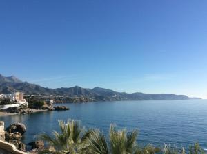 a view of a body of water with mountains in the background at Fuentes de Nerja in Nerja