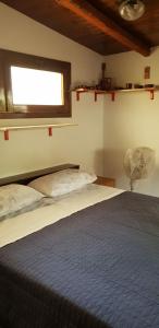a bedroom with a large bed with a window at Appartamenti Villa Wanda in Palmi