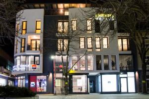 a building with lights on in a city at night at Boutique Apartments Blagoevgrad in Blagoevgrad