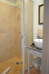 a bathroom with a shower and a sink at La Maison Des Buis in Falaise +36 photos