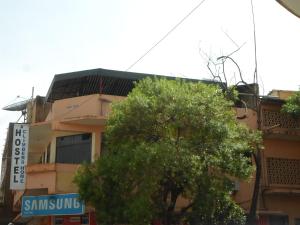 a building with a tree in front of it at Climbers Home in Moshi