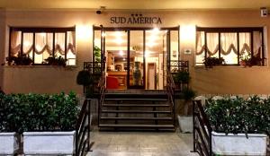 a building with stairs in front of a store at Hotel Sud America in Fiuggi
